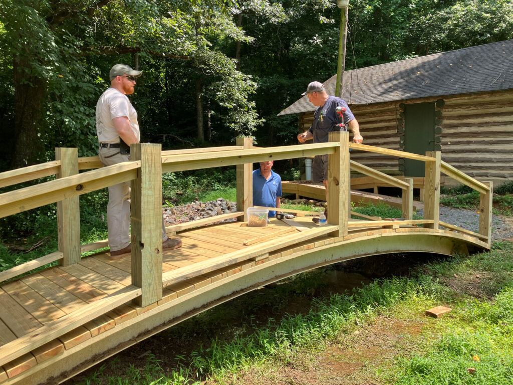 A Piece of History: Charlie, Mark and Dan rebuilding the bridge over the creek